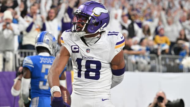 Justin Jefferson holds the ball while looking over his shoulder